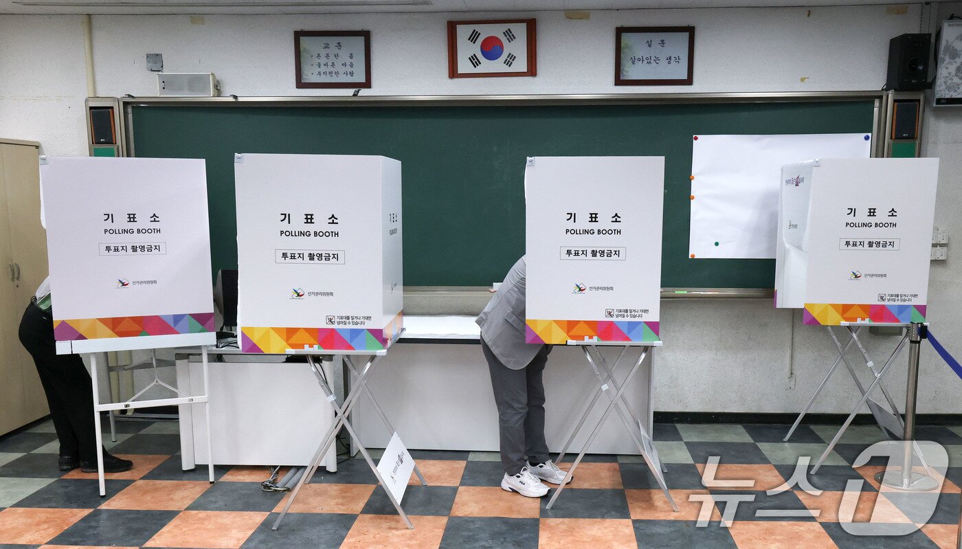 본문 이미지 - 제21대 대통령 선거일인 3일 서울 강동구 성내중학교 과학실험실에 마련된 성내1동 제2투표소에서 한 유권자들이 한표를 투표하고 있다. 2025.6.3/뉴스1 ⓒ News1 박세연 기자