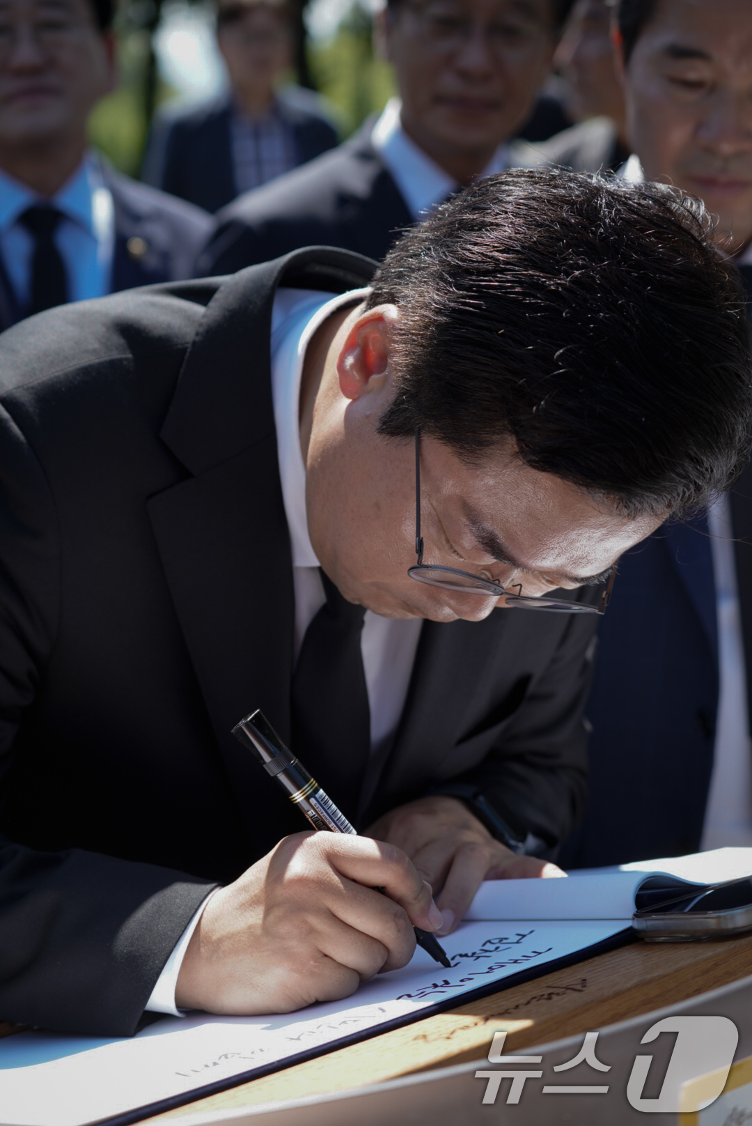 (김해=뉴스1) = 더불어민주당 당대표 후보에 출마한 박찬대 의원이 30일 경남 김해시 노무현 전 대통령 묘역을 찾아 방명록을 적고 있다. (박찬대 의원실 제공. 재판매 및 DB …