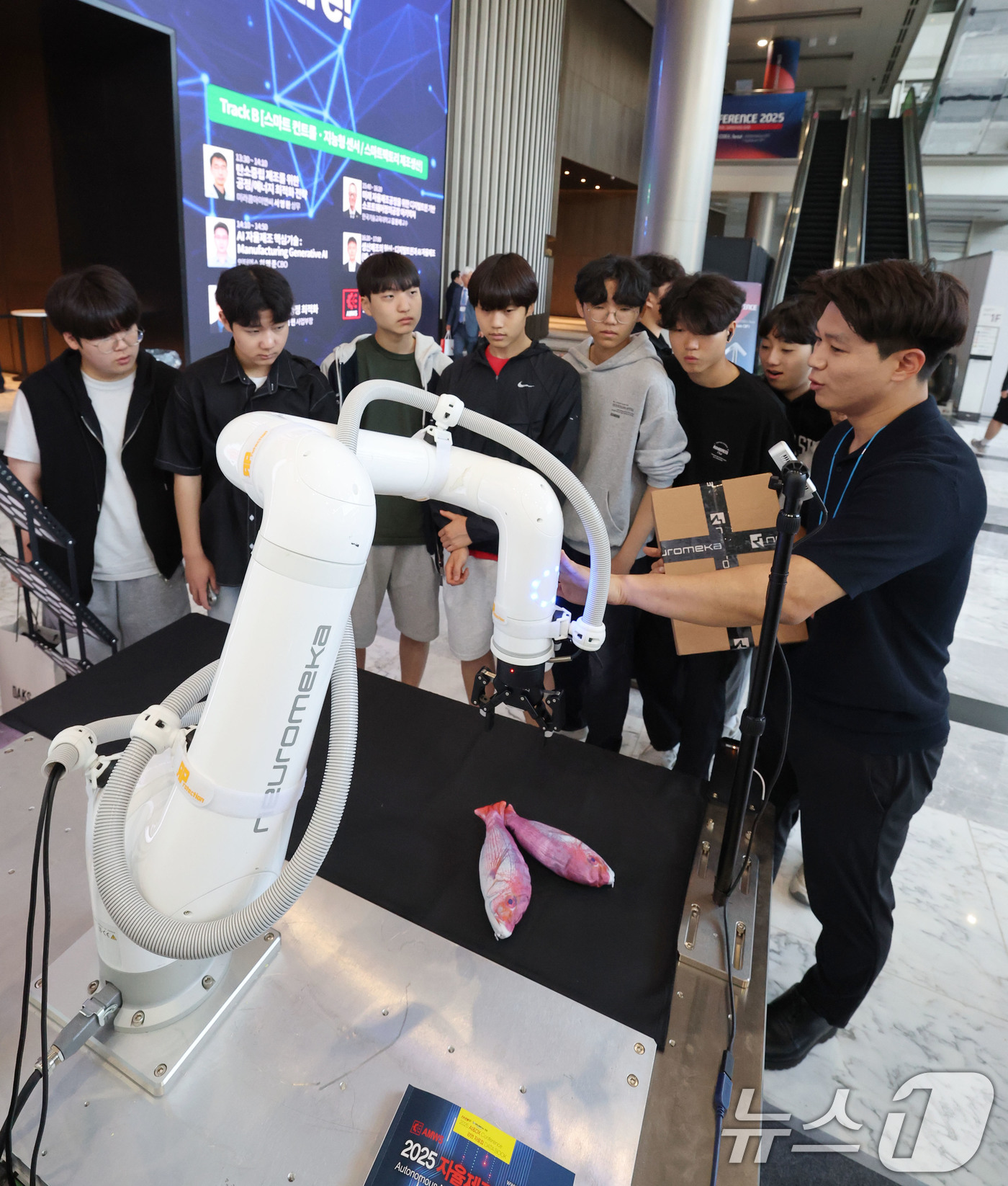 (서울=뉴스1) 박세연 기자 = 5일 서울 강남구 코엑스에서 열린 2025 자율제조 월드쇼를 찾은 관람객들이 산업용 협동로봇을 살펴보고 있다.이번 박람회는 스마트 제조솔루션과 인공 …