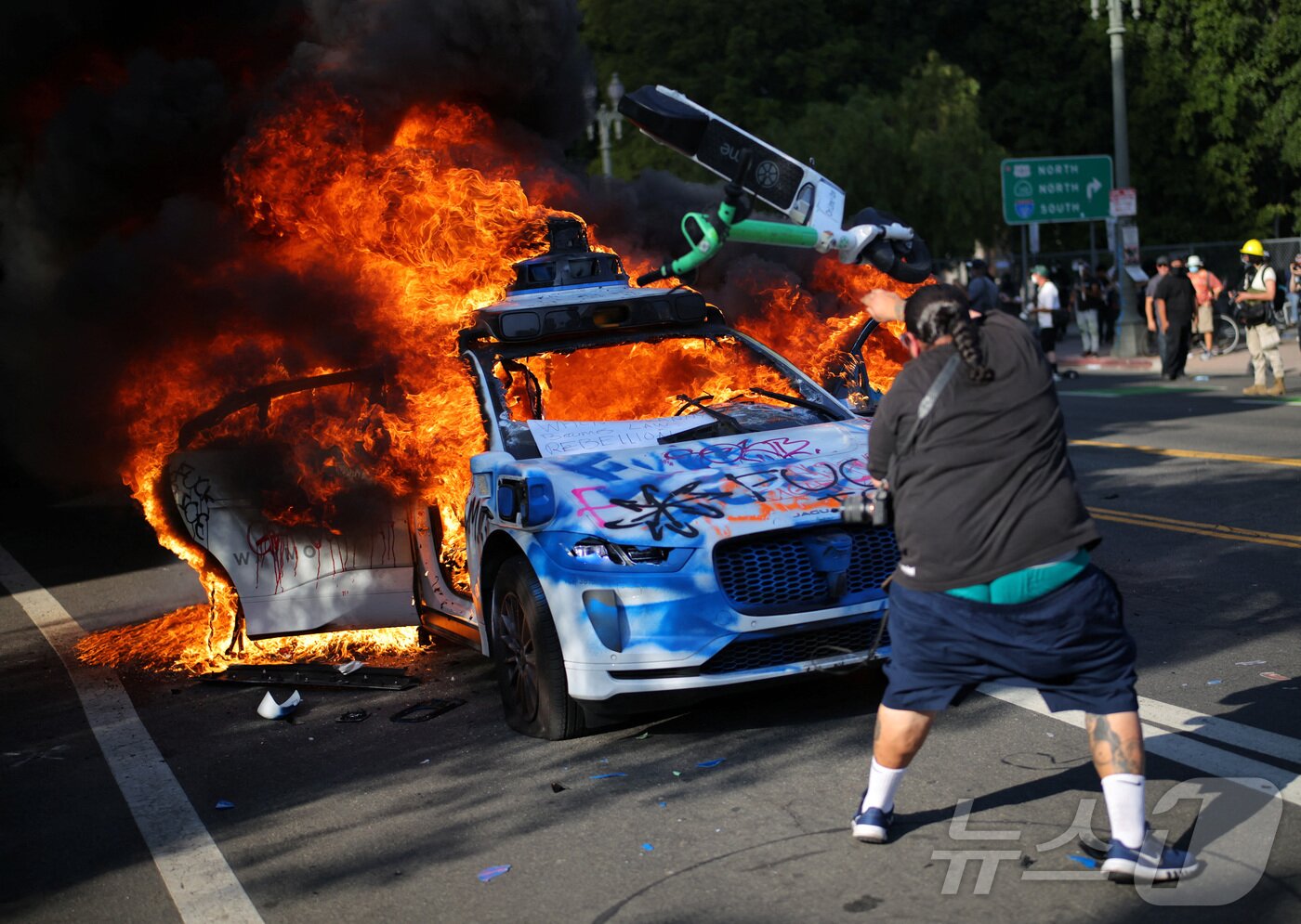 본문 이미지 - 8일(현지시간) 미국 LA에서 열린 연방 이민법 집행에 대한 항의 시위에서 차량이 불에 타고 있다. ⓒ 로이터=뉴스1