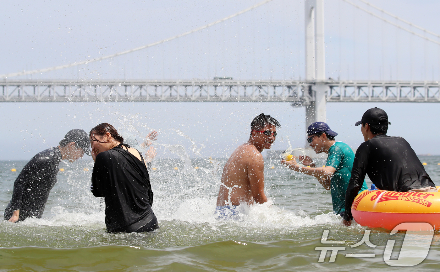 (부산=뉴스1) 윤일지 기자 = 무더위가 기승을 부린 1일 개장한 부산 수영구 광안리해수욕장을 찾은 관광객들이 물놀이를 즐기며 더위를 식히고 있다.부산 7개 해수욕장 중 해운대·송 …