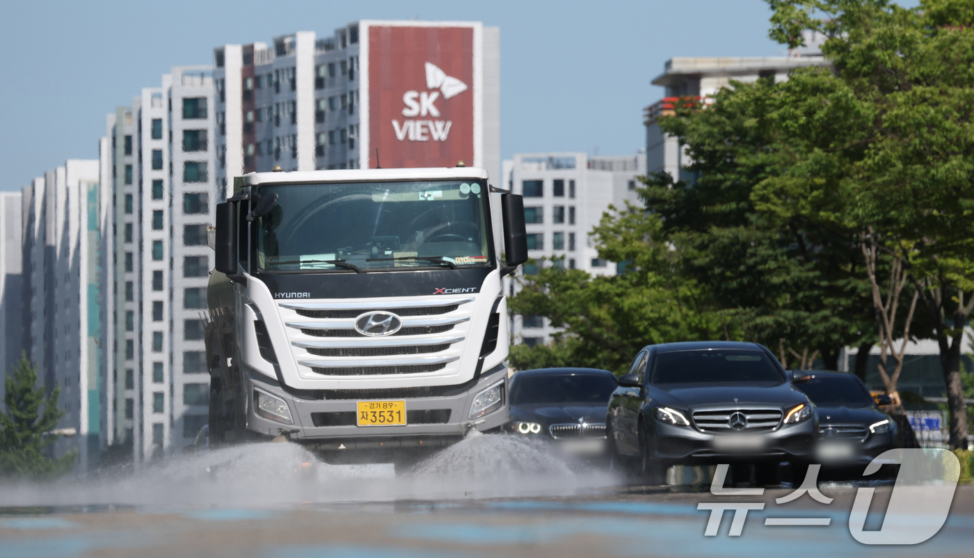 (수원=뉴스1) 김영운 기자 = 연일 폭염이 이어지고 있는 11일 경기 수원시 팔달구 수원시청 인근에서 구청 관계자가 살수차를 이용해 물을 뿌리고 있다. 2025.7.11/뉴스1