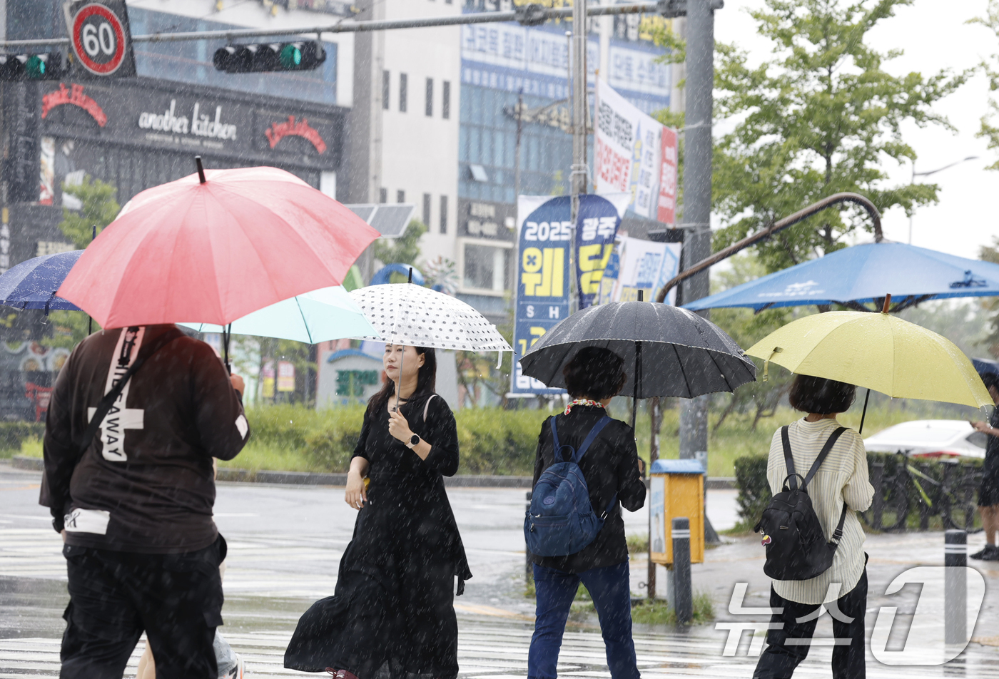 (광주=뉴스1) 김태성 기자 = 16일 오전 광주광역시 전역에 비가 내리는 가운데 광산구 수완지구 횡단보도를 시민들이 우산을 쓰고 걸어가고 있다. 2025.7.16/뉴스1