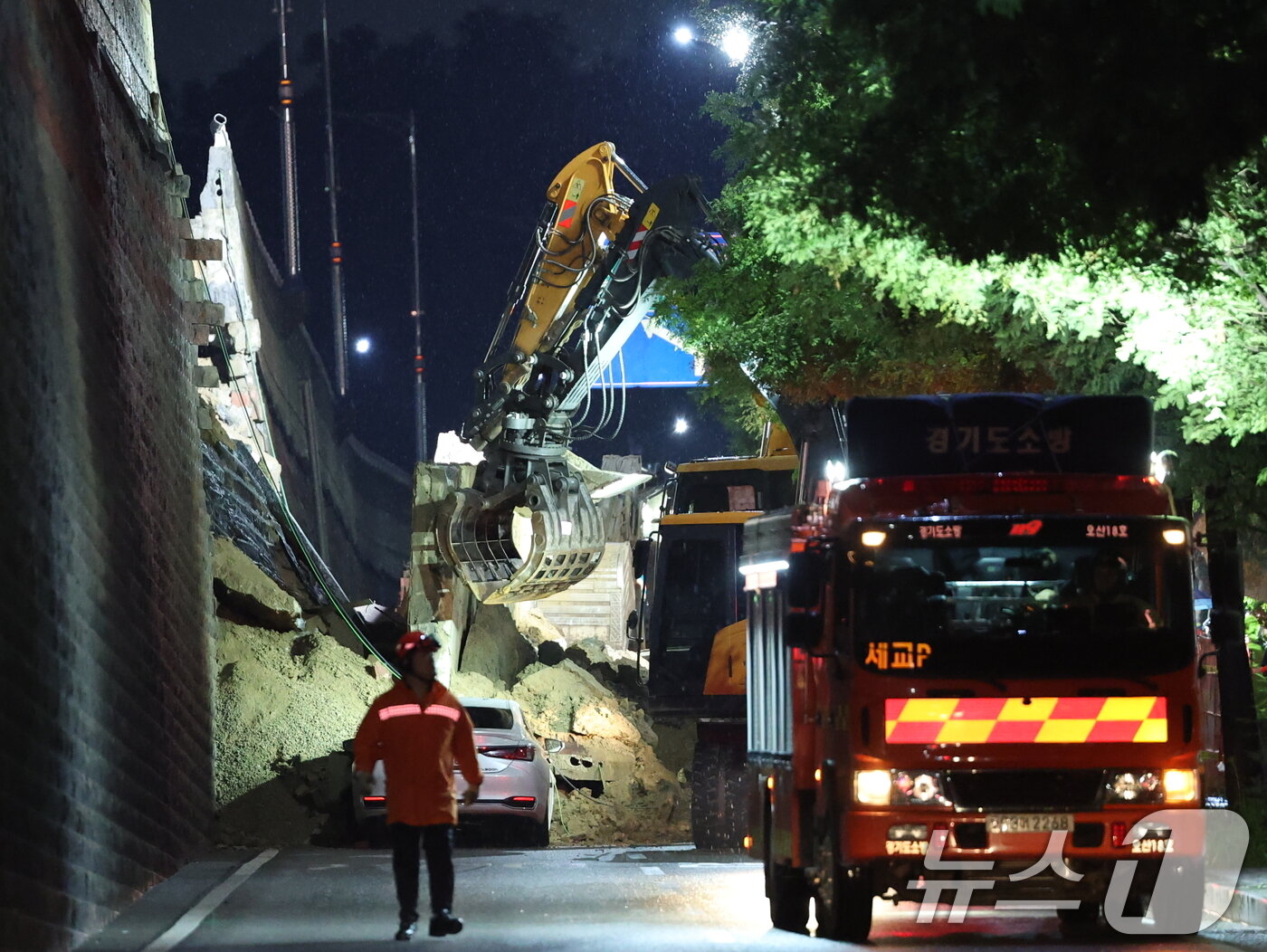 본문 이미지 - 16일 오후 경기 오산시 가장교차로 고가도로 옹벽이 무너져 소방관들이 매몰된 차량구조작업을 하고 있다. 2025.7.16/뉴스1 ⓒ News1 김영운 기자