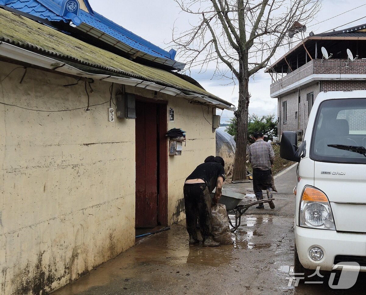 본문 이미지 -  19일 충남 예산 삽교읍 하포2의 침수된 주택 앞에서 이경우 씨와 그의 딸이 복구 작업 벌이고 있다. 2025.7.19/뉴스1 ⓒ News1 최형욱 기자 