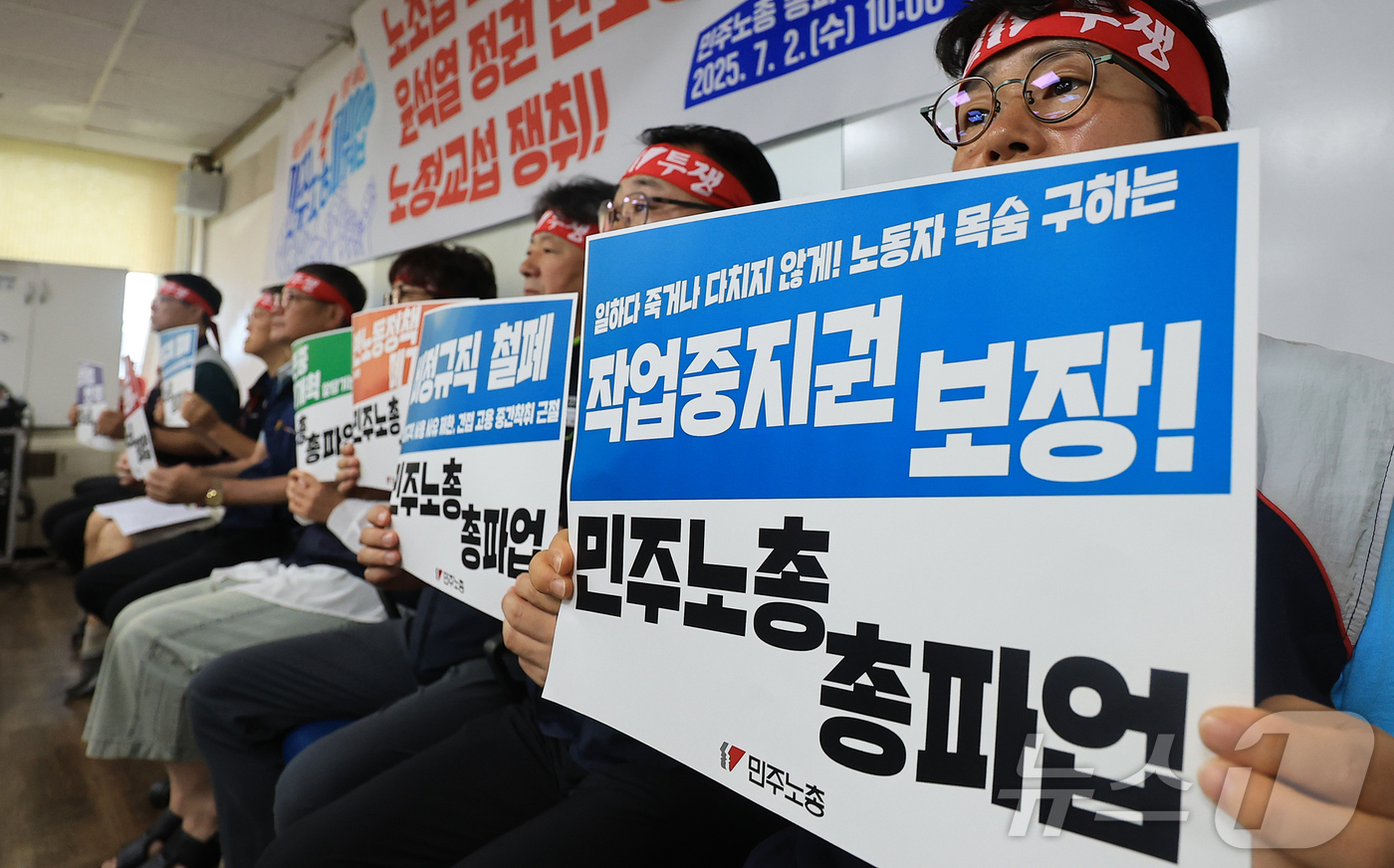 (서울=뉴스1) 김진환 기자 = 2일 오전 서울 중구 전국민주노동조합총연맹 사무실에서 열린 총파업 선포 전국동시다발 기자회견에서 민주노총 조합원이 '작업중지권 보장' 피켓을 들고 …