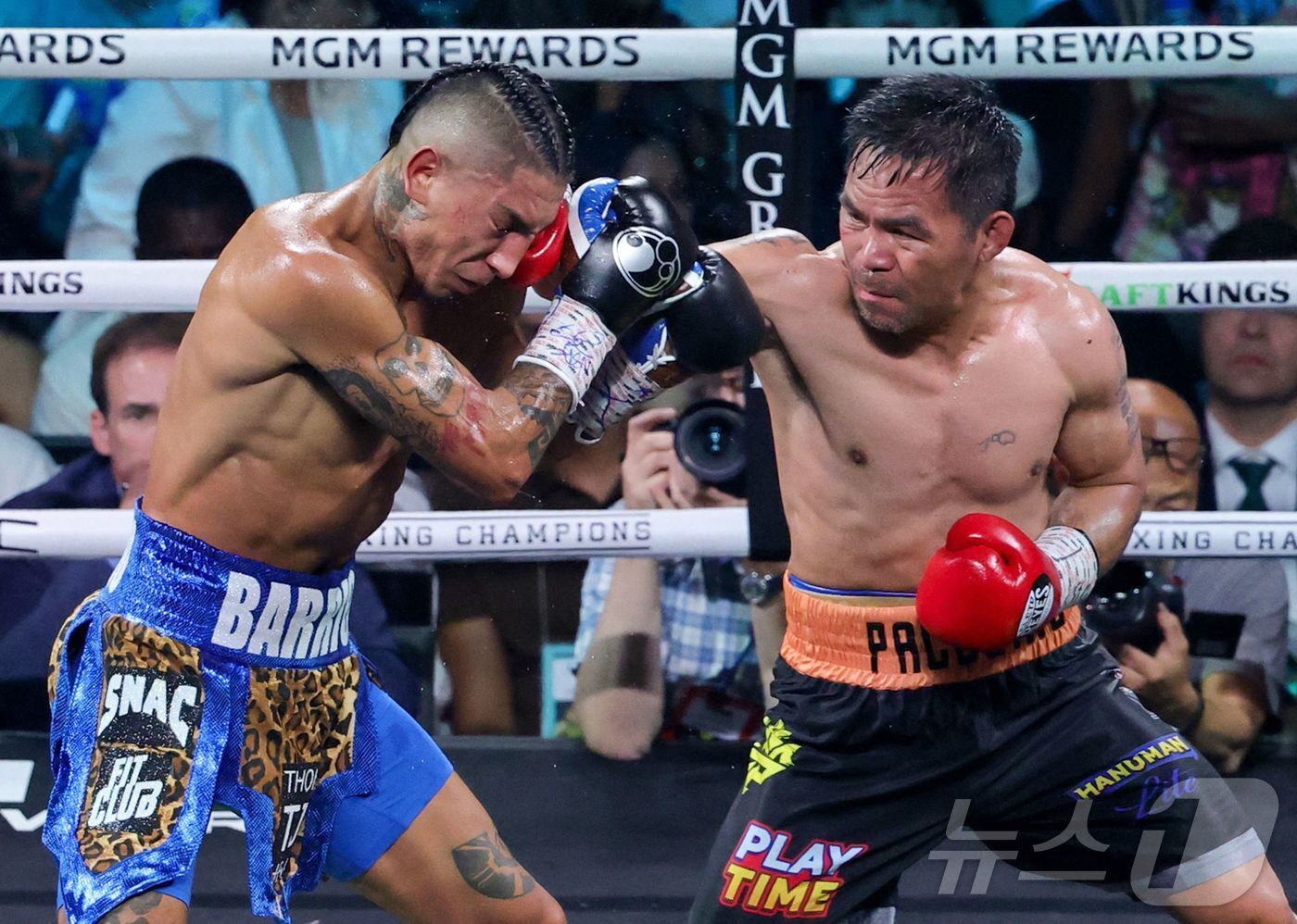 본문 이미지 - 파키아오(오른쪽)가 20일(한국시간) 미국 네바다주 라스베이거스의 MGM그랜드가든아레나에서 열린 WBC 웰터급 타이틀전에서 챔피언 바리오스와 경기하고 있다.  ⓒ AFP=뉴스1