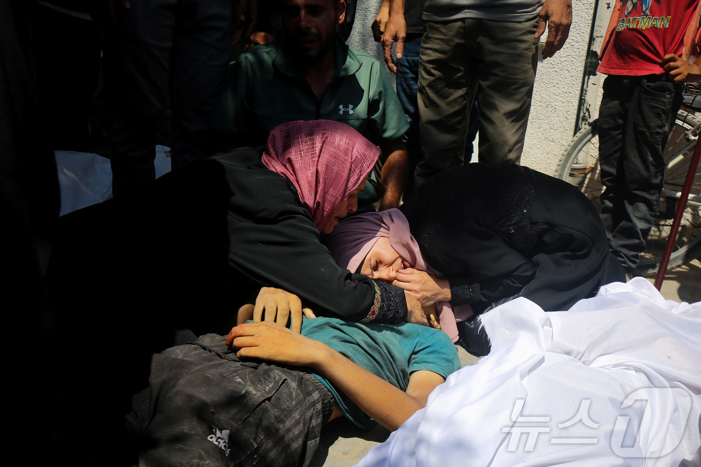 (가자 로이터=뉴스1) 윤다정 기자 = 20일(현지시간) 팔레스타인 주민들이 가자 북부에서 구호품을 기다리다 이스라엘군의 총격으로 숨진 희생자를 끌어안고 있다. 2025.07.20 …