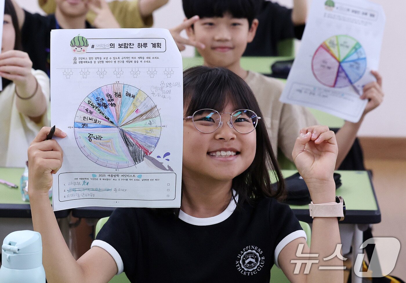 본문 이미지 - 23일 서울 동작구 삼일초등학교에서 열린 여름 방학식에서 학생들이 여름방학 계획표를 들어보이며 기뻐하고 있다. 2025.7.23/뉴스1 ⓒ News1 박지혜 기자