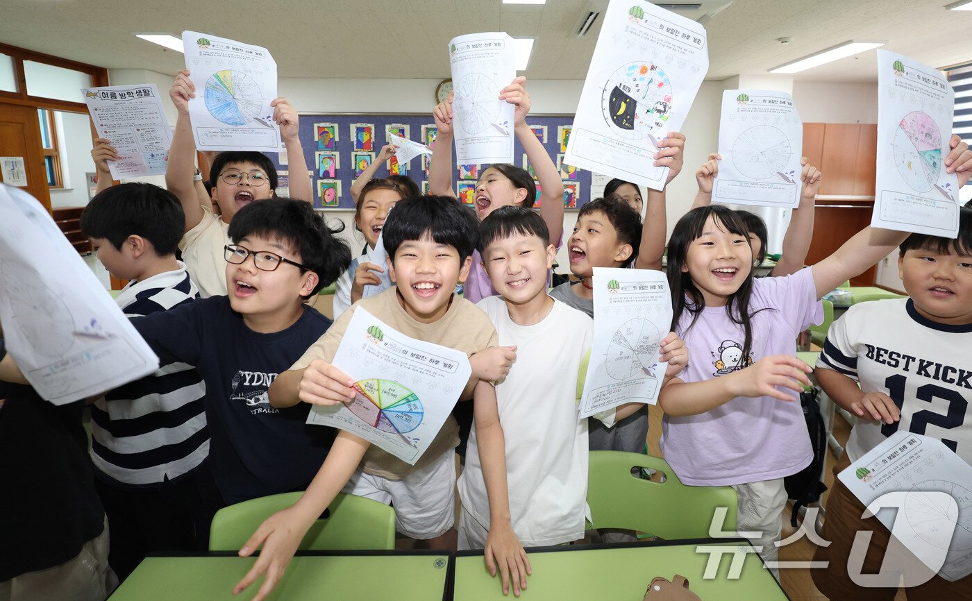 본문 이미지 - 23일 서울 동작구 삼일초등학교에서 열린 여름 방학식에서 학생들이 여름방학 계획표를 들어보이며 기뻐하고 있다. 2025.7.23/뉴스1 ⓒ News1 박지혜 기자