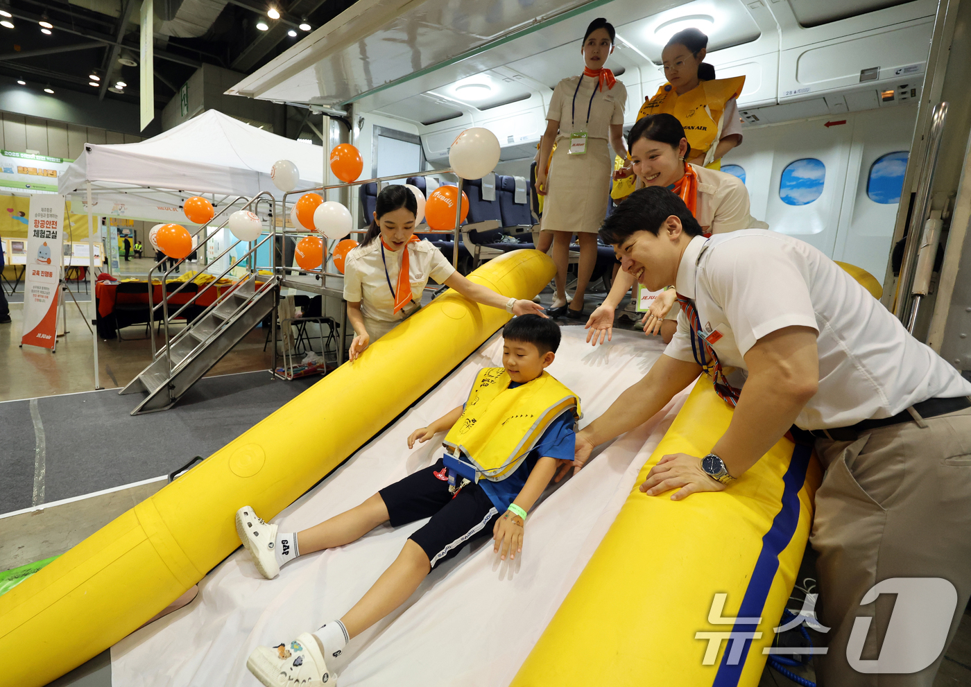 (고양=뉴스1) 황기선 기자 = 24일 경기 고양시 일산서구 킨텍스에서 열린 '2025 어린이 안전 박람회'에서 어린이들이 제주항공 승무원들에게 항공 안전체험을 배우고 있다. 20 …