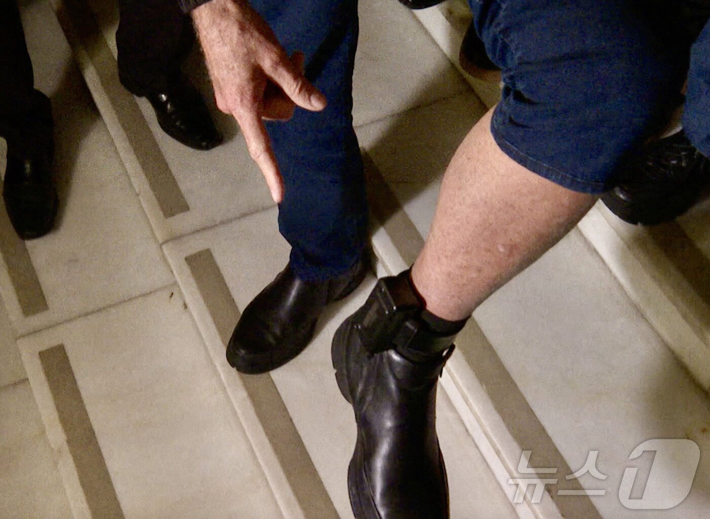 본문 이미지 - 21일(현지시간) 브라질 브라질리아 연방 의회 앞에서 자이르 보우소나루 전 브라질 대통령이 전자 발찌를 가리켜 보이고 있다. 2025.07.21. ⓒ AFP=뉴스1 ⓒ News1 윤다정 기자