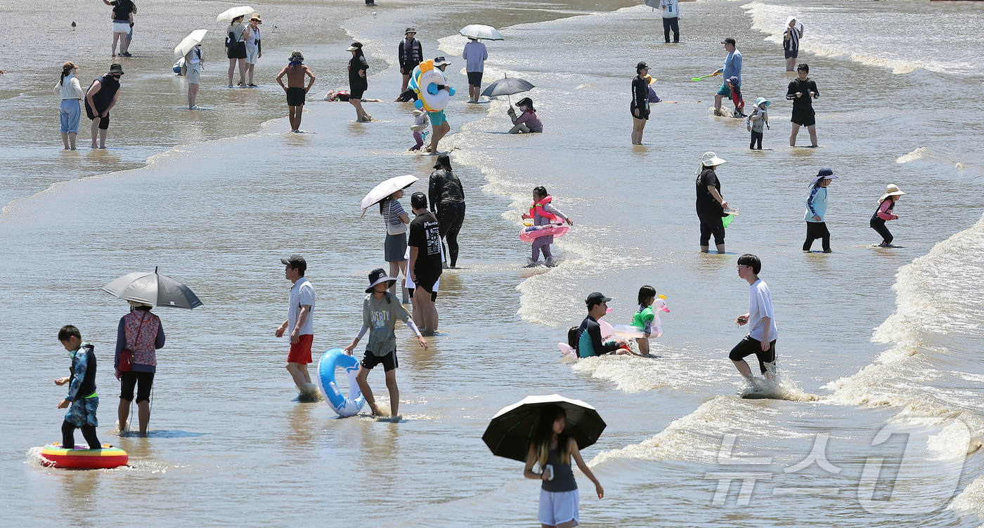(인천=뉴스1) 김진환 기자 = 전국 대부분 지역에 폭염특보가 내려진 27일 오후 인천 중구 을왕리 해수욕장을 찾은 시민들이 더위를 식히고 있다. 2025.7.27/뉴스1