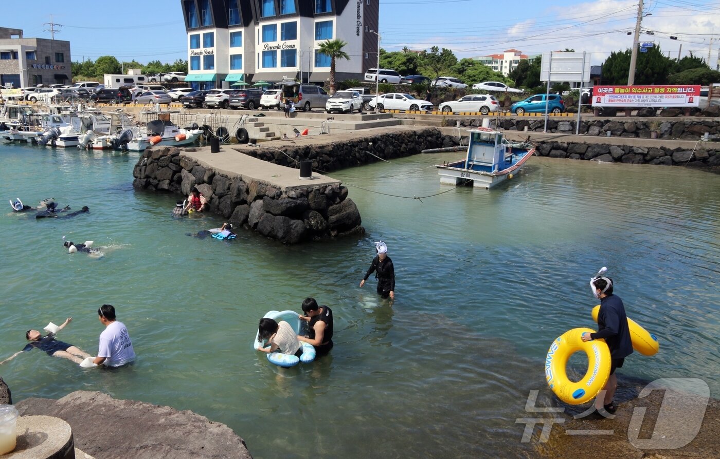 본문 이미지 - 27일 오후 제주시 한림읍 월령포구에서 사람들이 물놀이를 하고 있다. 하루 전 이곳에서는 20대 남성이 물놀이 중 익수사고로 사망했다.2025.7.27/뉴스1 ⓒ News1 홍수영 기자