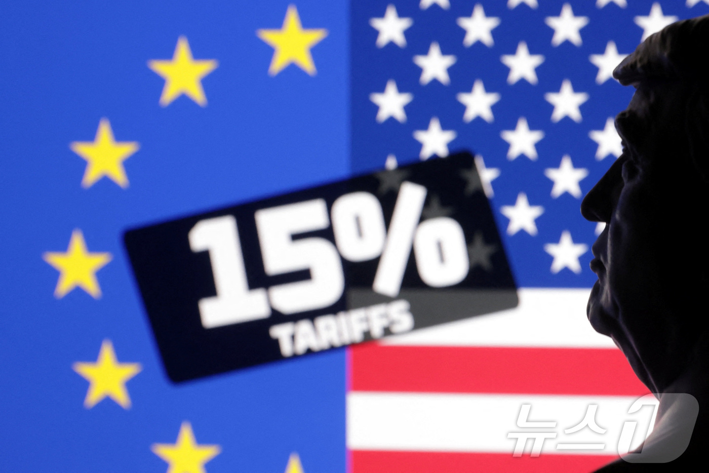 (로이터=뉴스1) 강민경 기자 = 27일 유럽연합기와 성조기 앞에 도널드 트럼프 미국 대통령의 미니어처 조형물이 놓여 있다. 2025.7.27ⓒ 로이터=뉴스1