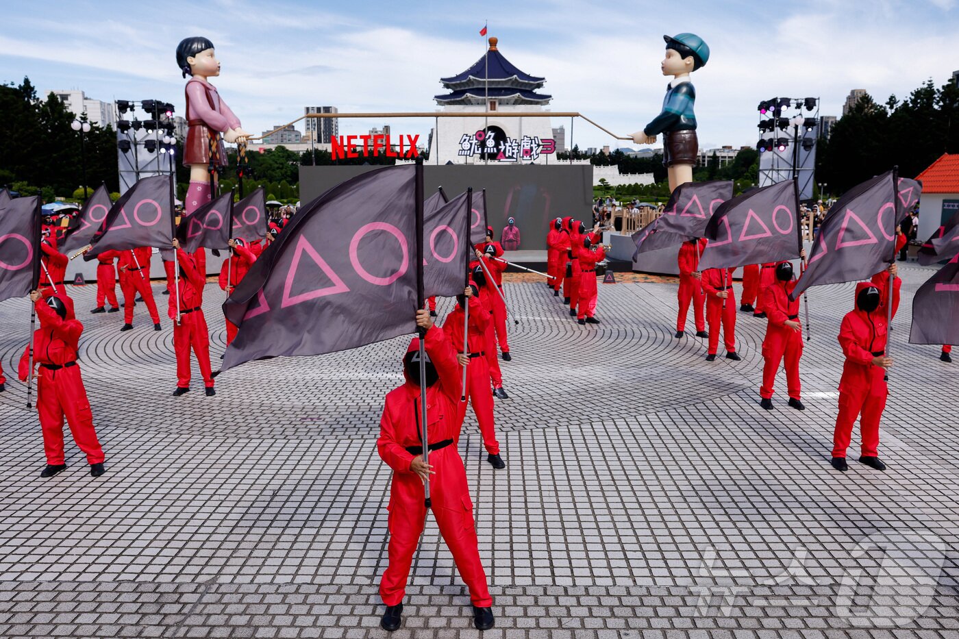 본문 이미지 - 지난 29일(현지시간)  대만 타이베이 중정기념당 광장에서 열린 '오징어 게임 3' 홍보 행사에서 캐릭터로 분장한 사람들이 공연을 펼치고 있다. ⓒ 로이터=뉴스1