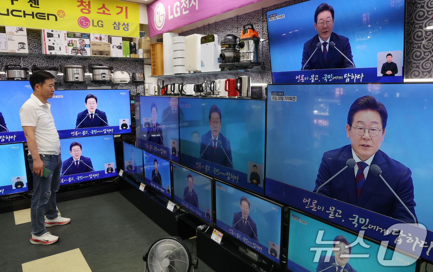 (서울=뉴스1) 김명섭 기자 = 3일 서울 용산구 전자랜드 매장에서 상인이 '대통령의 30일, 언론이 묻고 국민에게 답하다'라는 이재명 대통령 기자회견을 보고 있다. 2025.7. …