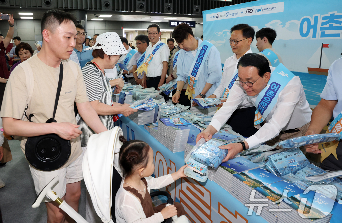 (서울=뉴스1) 김명섭 기자 = 노동진 수협중앙회장이 30일 서울 SRT수서역에서 열린 여름휴가 어촌에서 보내기 캠페인에서 시민들에게 여름철 휴가지로 각광받는 어촌마을 안내 책자인 …
