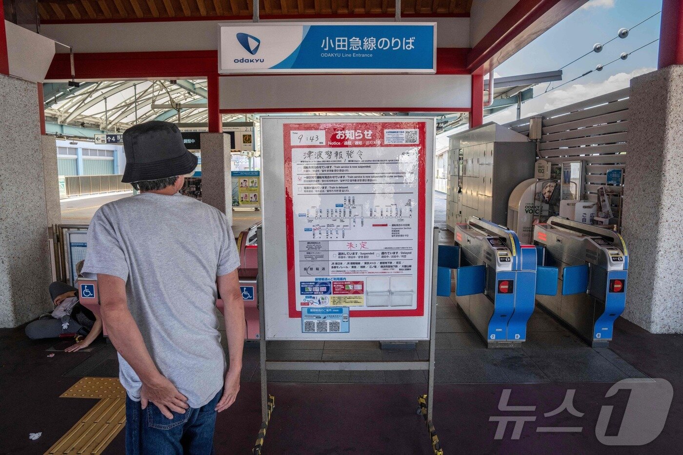 본문 이미지 - 러시아 극동 캄차카반도 동쪽 해역에서 규모 8.8 강진이 발생한 30일 일본 가나가와현 후지사와시에서 쓰나미 경보로 폐쇄된 가타세 에노시마역에서 한 남성이 안내문을 확인하고 있습니다. ⓒ AFP=뉴스1 ⓒ News1 박세연 기자