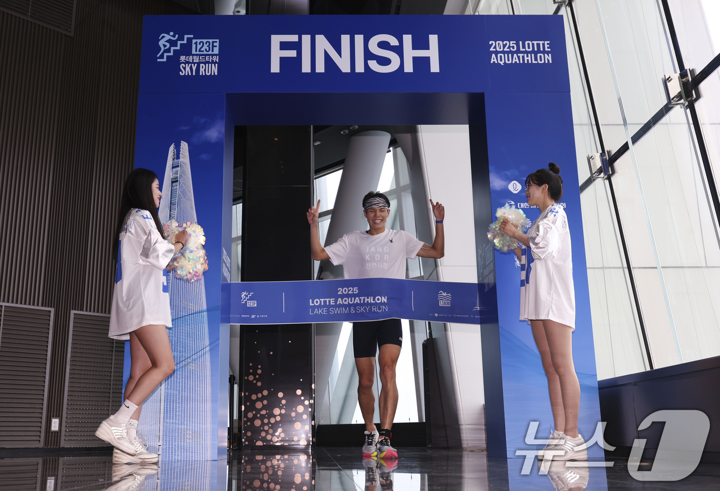 (서울=뉴스1) 김성진 기자 = 6일 오전 서울 송파구 잠실 롯데월드타워에서 열린 2025 롯데 아쿠아슬론에서 한 참가자가 결승점을 통과하고 있다.올해로 4회째를 맞이한 '롯데 아 …