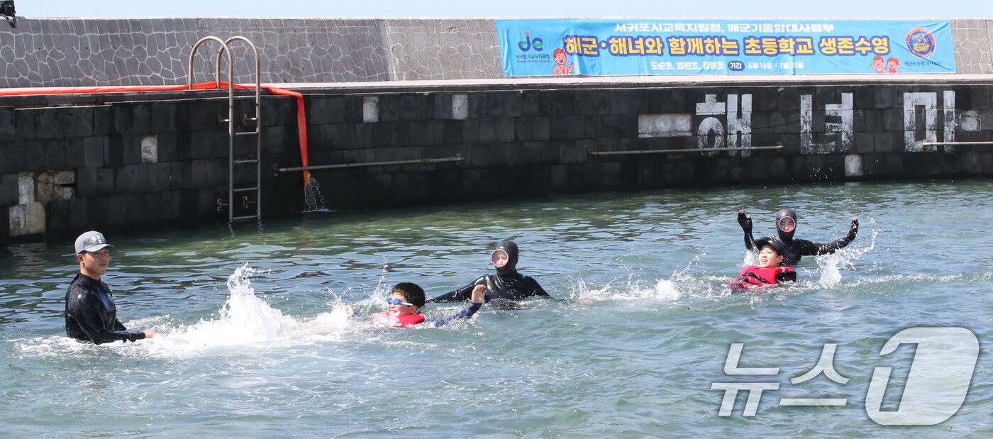 본문 이미지 - 8일 오전 제주 서귀포시 법환어촌계 해녀체험장에서 강정초등학교 학생들이 해녀와 해군 해난구조대&#40;SSU&#41;로부터 &#39;제주형 생존수영&#39; 교육을 받고 있다. 2025.7.8/뉴스1 ⓒ News1 오현지 기자