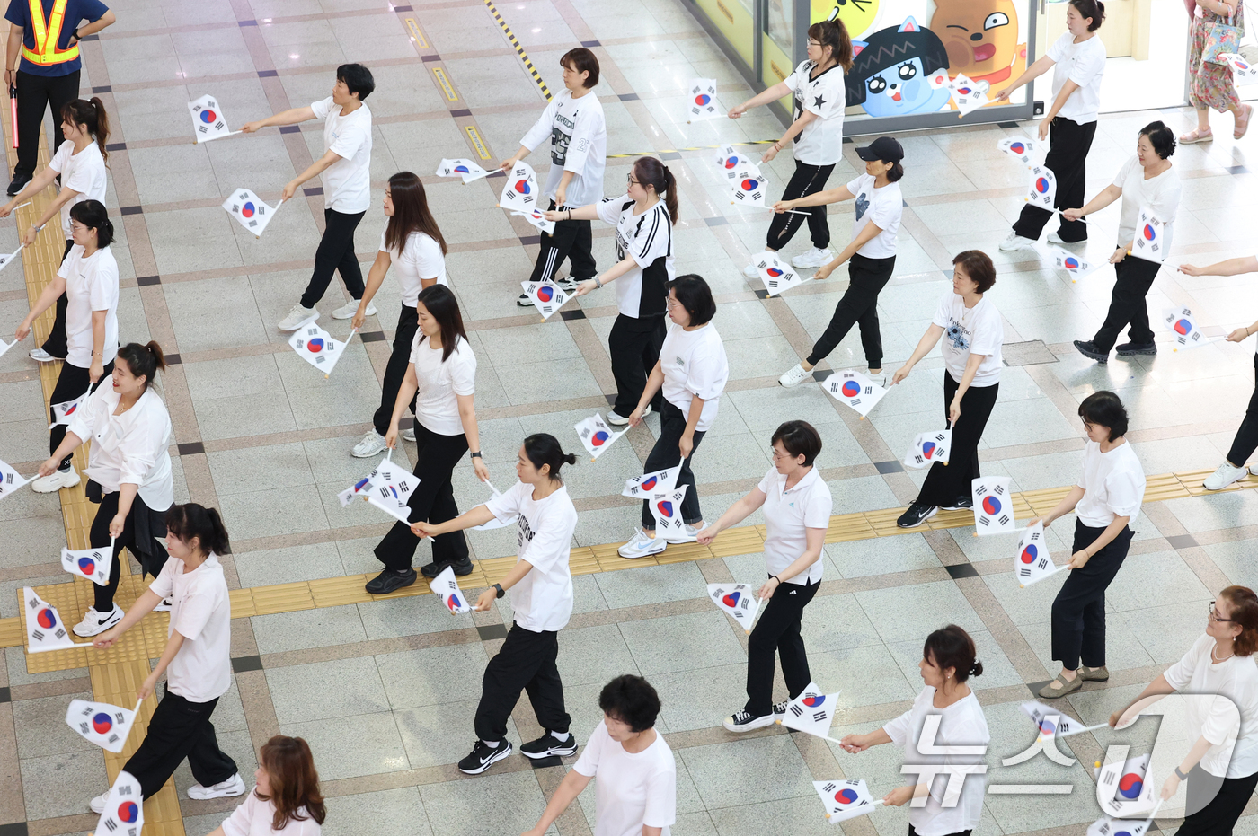 (수원=뉴스1) 김영운 기자 = 제80주년 광복절을 나흘 앞둔 11일 오후 경기 수원시 팔달구 수원역 대합실에서 권선구 관내 주민자치센터 댄스수강생들이 광복 80주년 기념 플래시몹 …