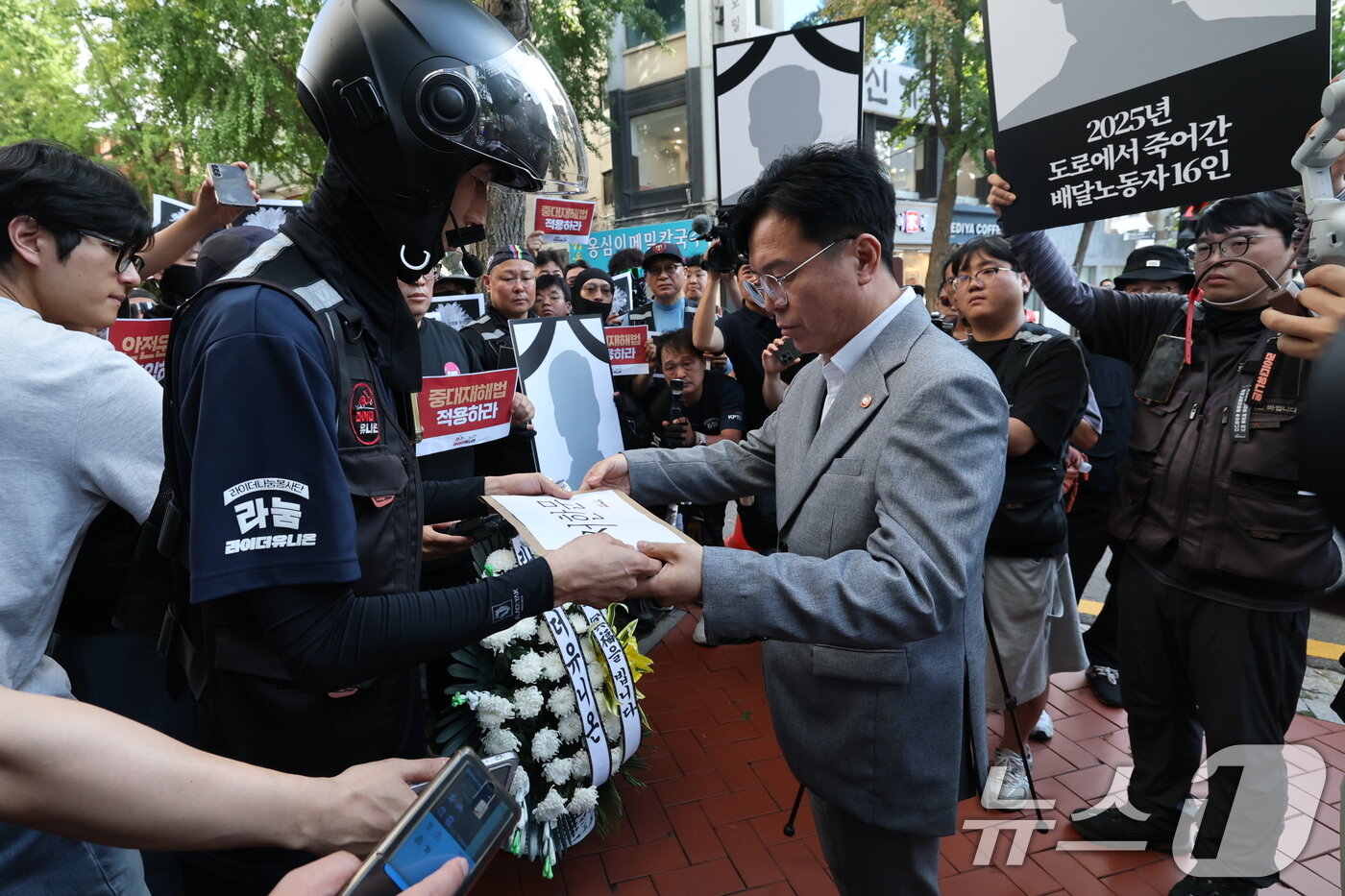 본문 이미지 - 김영훈 고용노동부 장관이 지난해 서울 중구 민주노총에서 열린 간담회에 앞서 라이더유니온 조힙원들로부터 배달노동자 산재 사고 대책을 촉구하는 서한문을 전달받고 있다. ⓒ News1 오대일 기자