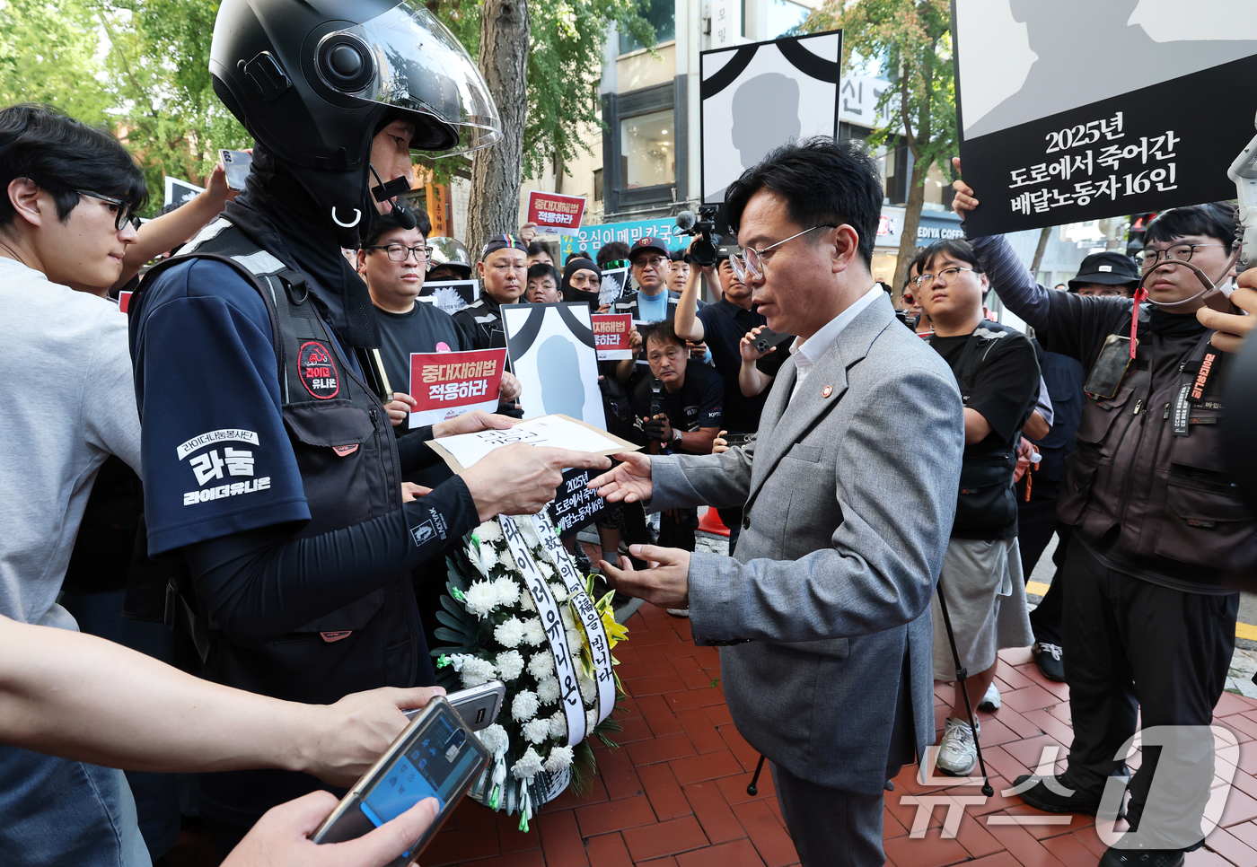 (서울=뉴스1) 오대일 기자 = 김영훈 고용노동부 장관이 12일 오후 서울 중구 민주노총에서 열린 간담회에 앞서 라이더유니온 조합원들로부터 배달노동자 산재 사고 대책을 촉구하는 서 …