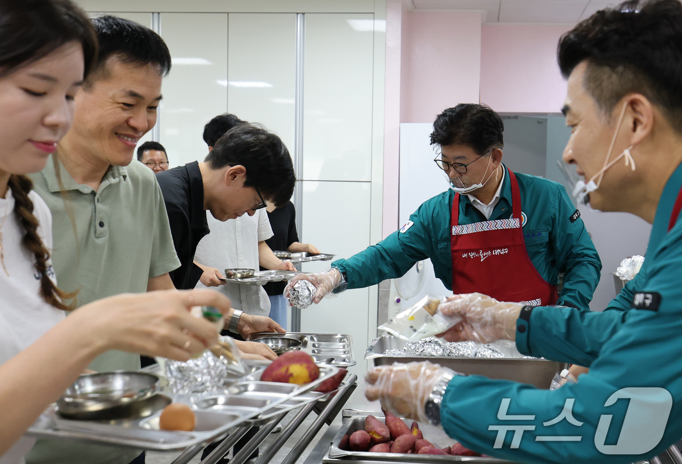 (대전=뉴스1) 김기태 기자 = 2025년 을지연습 첫날인 18일 대전 대덕구청 구내식당에서 최충규 구청장이 비상식량인 주먹밥과 고구마를 배식하고 있다.구는 이날 국가비상사태 시 …