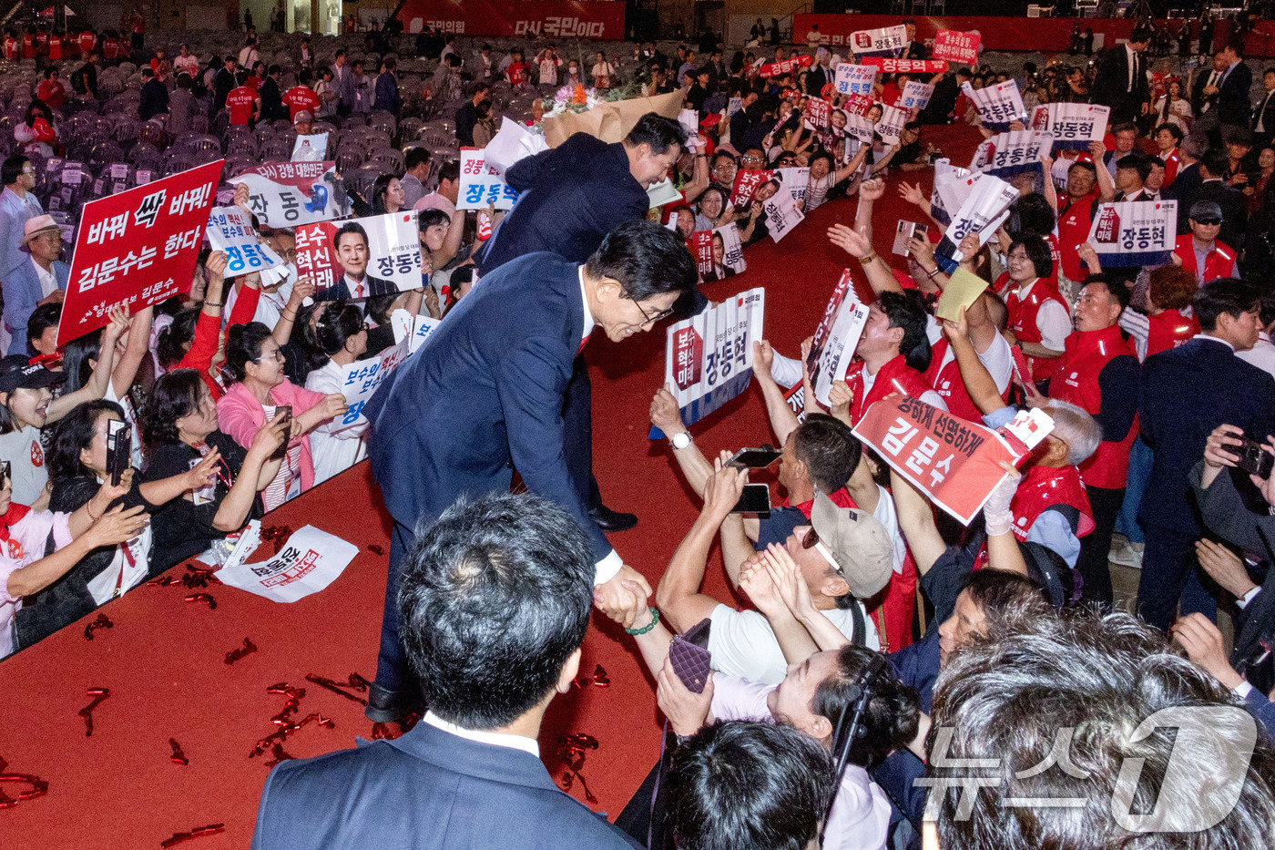 (청주=뉴스1) 신웅수 기자 = 국민의힘 당 대표 결선투표 진출자 김문수, 장동혁 후보가 22일 오후 충북 청주시 오스코에서 열린 제6차 전당대회에서 발언을 마친 후 지지자들과 인 …