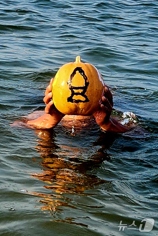 (포항=뉴스1) 최창호 기자 = 독도 서예가로 활동 중인 서예가 김동욱 씨가 26일 경북 포항시 송도해수욕장에서 북구 기계면 인비리 암각화 공원(원장 이호우) 홍보 퍼포먼스를 펼치 …