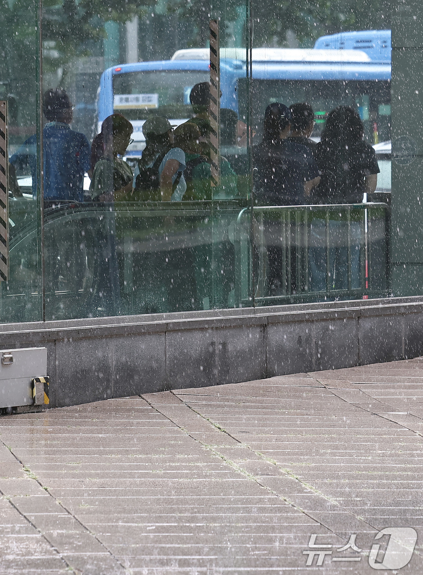 (서울=뉴스1) 구윤성 기자 = 29일 오후 서울 종로 일대 지하철역 출구에서 우산을 챙기지 못한 시민들이 소나기가 그치기를 기다리고 있다. 2025.8.29/뉴스1