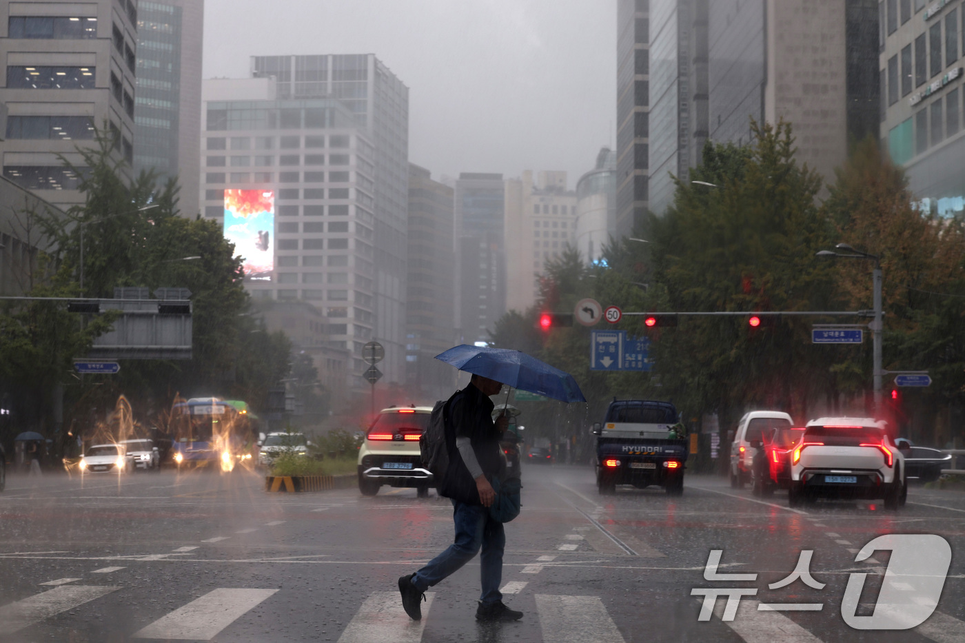 (서울=뉴스1) 구윤성 기자 = 서울 등 수도권과 충청지역에 호우 예비특보가 내려진 6일 오후 서울 종로 거리에서 우산을 쓴 시민이 비를 피해 걷고 있다. 2025.8.6/뉴스1