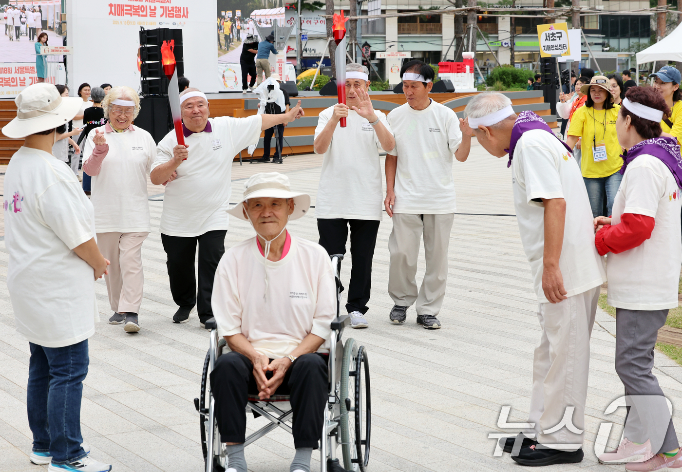 (서울=뉴스1) 황기선 기자 = 19일 오전 서울광장에서 열린 '제18회 치매극복의 날 기념행사'에서 참석자들이 성화 봉송 릴레이를 하고 있다.  2025.9.19/뉴스1