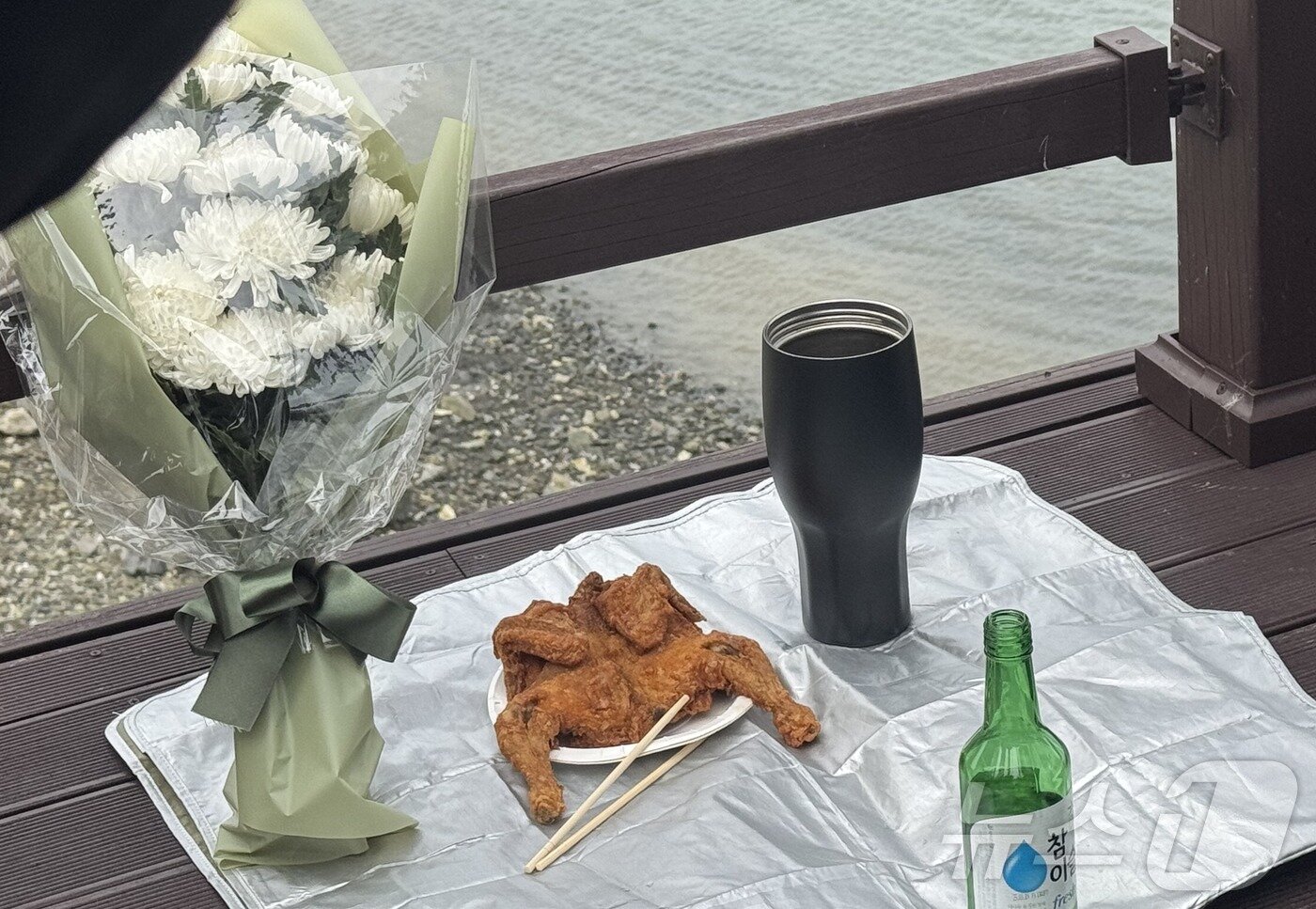 본문 이미지 - 22일 인천 옹진군 영흥도 돌고래전망대 앞 숨진 해양경찰관 이재석 경사의 마지막 가는 길을 기리며 유족들이 마련한 추모식. 이 경사가 생전 좋아하는 커피와 치킨 등을 마련해놓았다.2025.9.22/뉴스1 ⓒ News1 박소영 기자