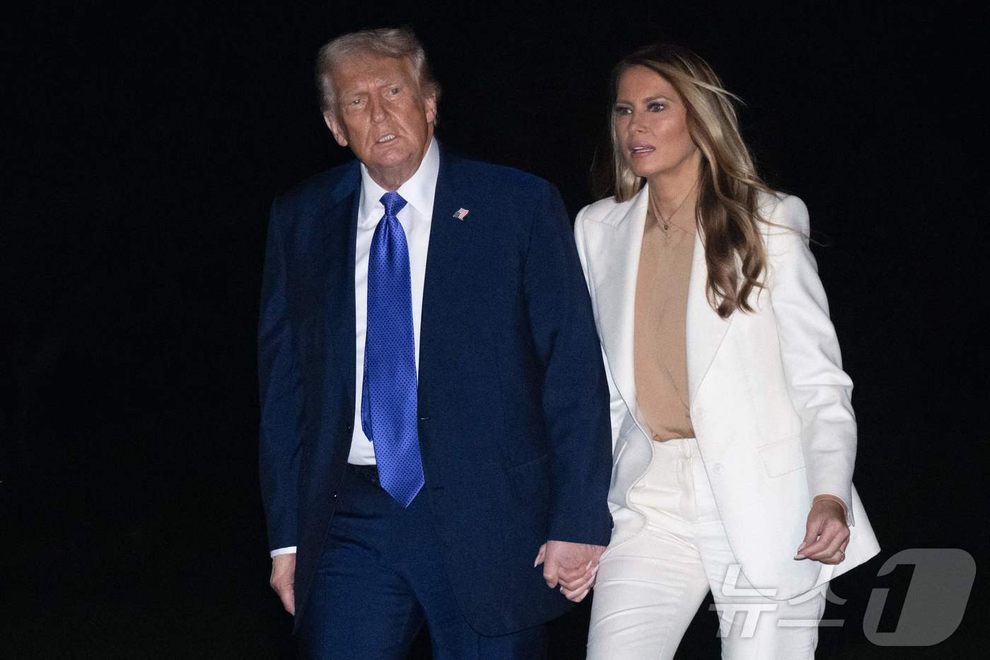 본문 이미지 - 트럼프 미국 대통령과 부인 멜라니아 여사가 대통령 전용 헬리콥터 &#39;마린 원&#39;으로 백악관에 도착한 뒤 하차해 이동하는 모습. 2025.09.23. ⓒ AFP=뉴스1 ⓒ News1 이지예 객원기자