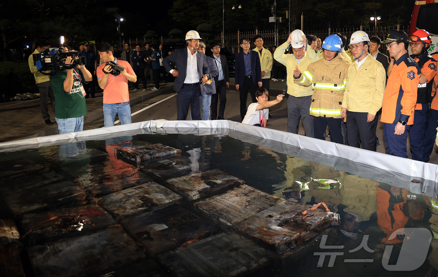 (대전=뉴스1) 김진환 기자 = 김민석 국무총리가 27일 대전 유성구 국가정보자원관리원 화재 현장을 찾아 소화수조에 담긴 불에 탄 리튬이온 배터리를 살펴보고 있다. 2025.9.2 …
