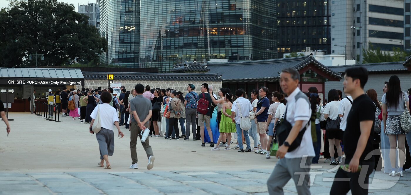 본문 이미지 - 경복궁 야간 관람이 시작된 3일 오후 서울 종로구 경복궁을 찾은 외국인 관광객들이 현장판매줄에 서서 대기하고 있다.  2025.9.3/뉴스1 ⓒ News1 김진환 기자