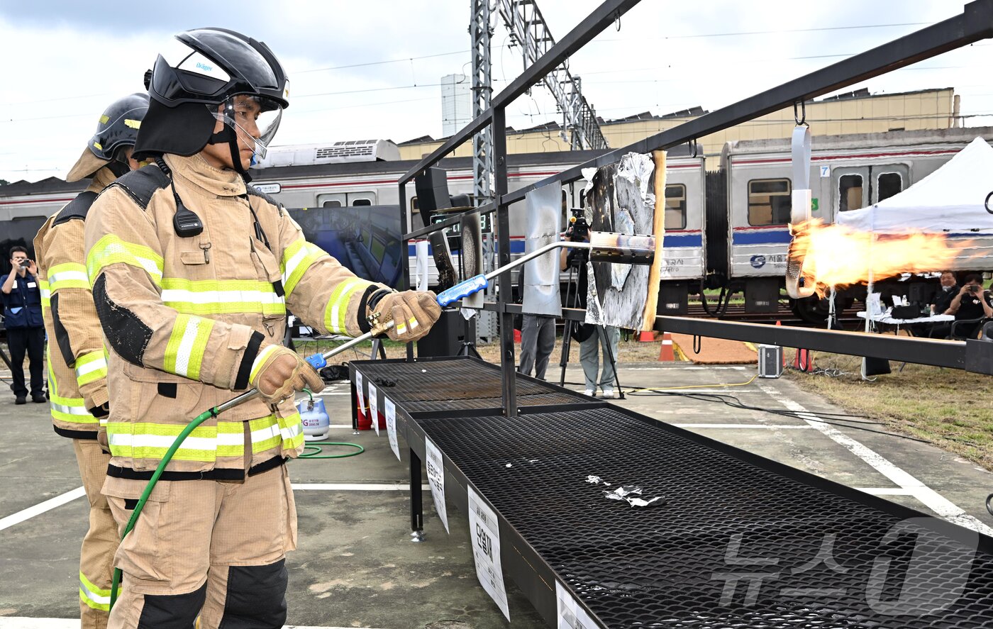 본문 이미지 - 4일 오후 경기 고양시 지축차량기지에서 열린 5호선 열차 방화관련 화재안정성 및 비상대응 검증을 위한 전동차 화재안전 시연회에서 소방 관계자가 전동차 내장재 6종에 대한 방염 성능 테스트를 하고 있다. &#40;공동취재&#41; 2025.9.4/뉴스1 ⓒ News1 김진환 기자