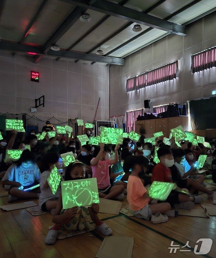 본문 이미지 -  &#39;지구 지킴이 콘서트&#39;에서 학생들이 형광펜으로 지구사랑 글씨를 쓴 뒤 들어보이고 있다.&#40;전남도교육청 제공, 재판매 및 DB 금지&#41;/뉴스1 