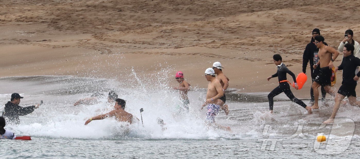 본문 이미지 - 2026년 새해 첫날인 1일 오전 제주 서귀포시 중문색달해수욕장에서 열린 제27회 서귀포 겨울바다 국제펭귄수영대회에서 참가자들이 바다를 향해 달려가고 있다. 2026.1.1/뉴스1 ⓒ News1 강승남 기자