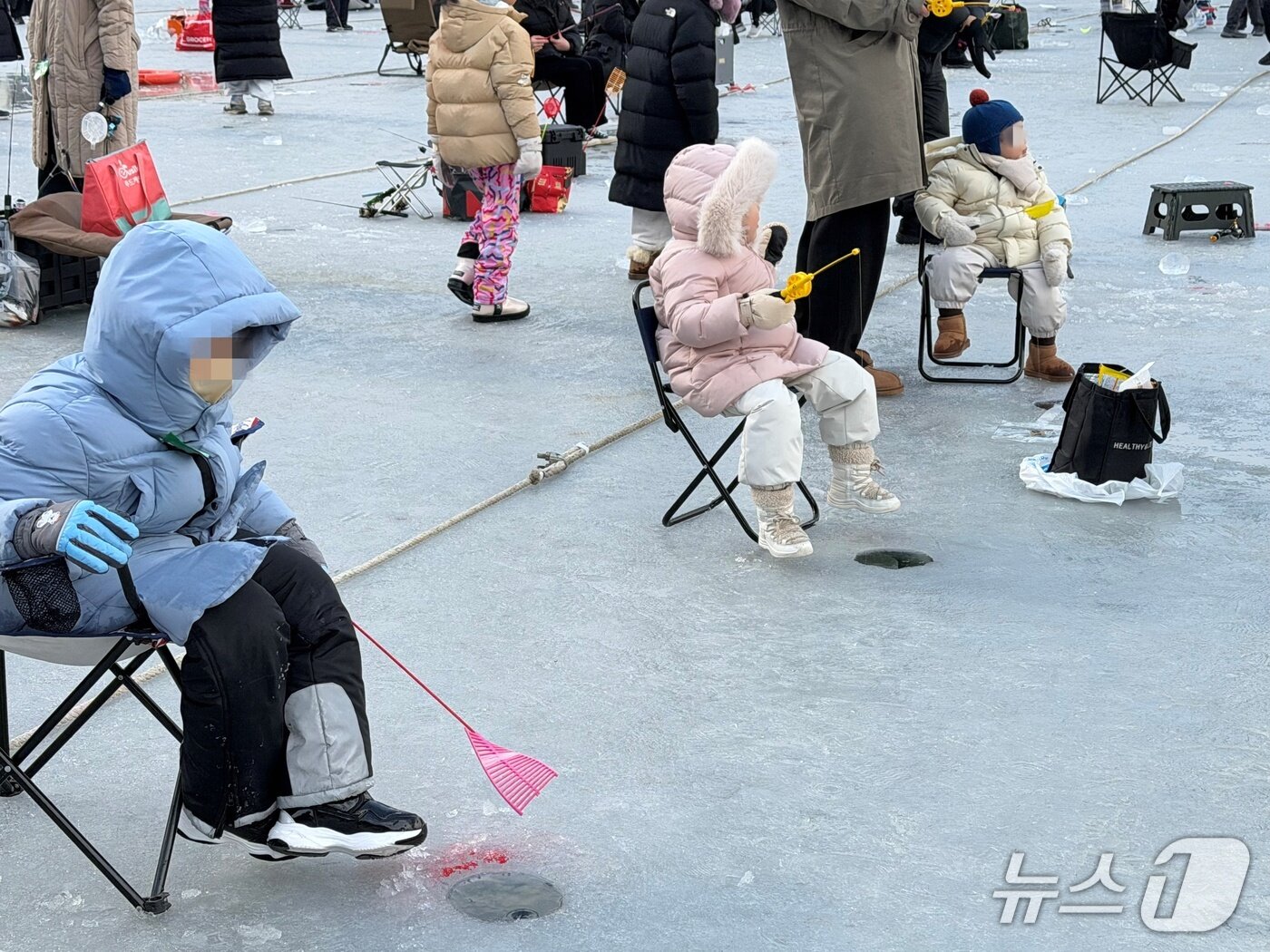 본문 이미지 - '2026 얼음나라 화천산천어축제' 첫날인 10일 축제장을 찾은 어린이 낚시꾼들이 자리를 잡고 앉아 산천어 잡기에 한창이다.2026.1.10 한귀섭 기자 
