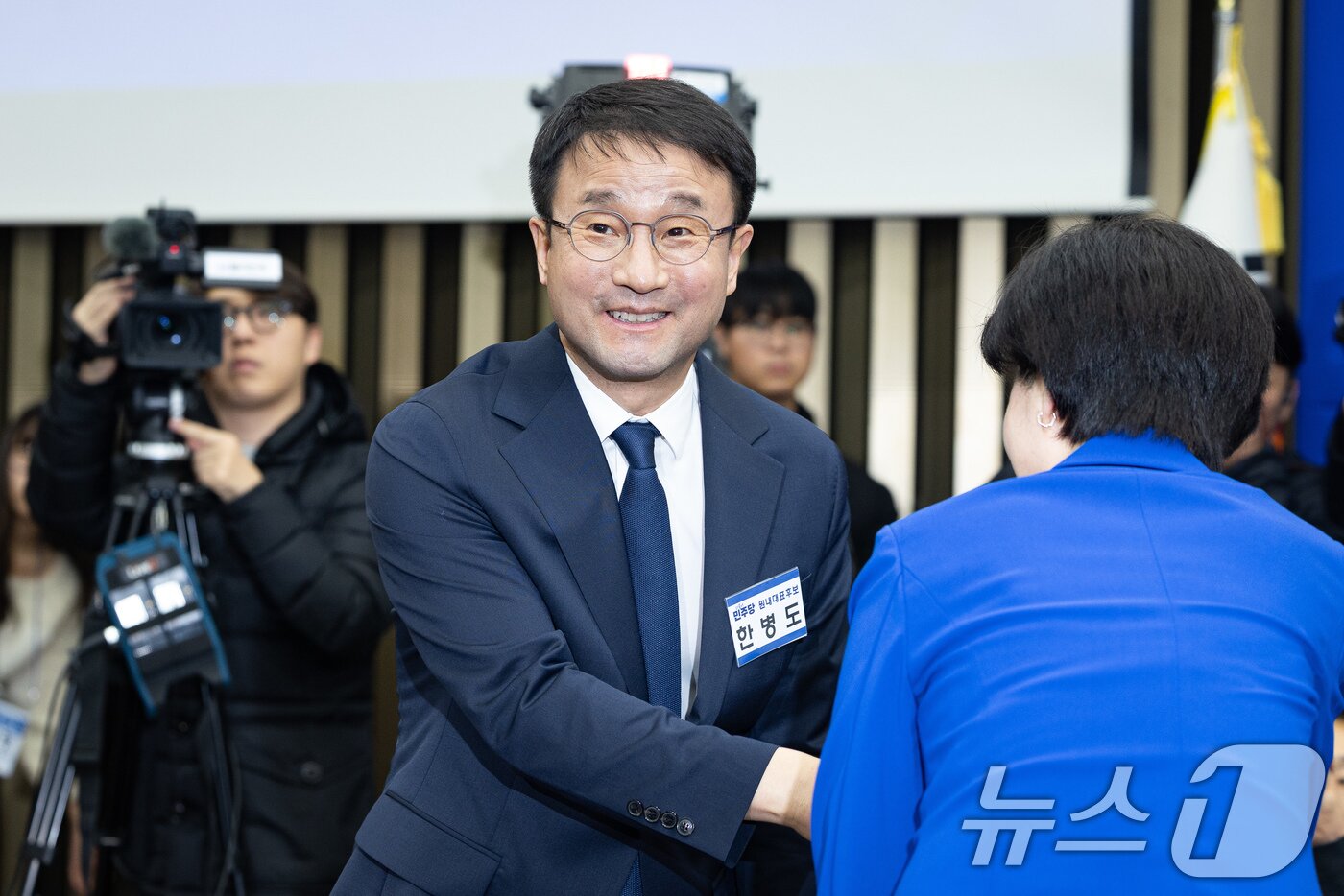 본문 이미지 - 더불어민주당 신임 원내대표로 선출된 한병도 의원이 11일 서울 여의도 국회에서 열린 제22대 국회 더불어민주당 원내대표 선출을 위한 의원총회에서 백혜련 의원과 인사를 나누며 의원들을 바라보고 있다. 2026.1.11/뉴스1 ⓒ News1 유승관 기자