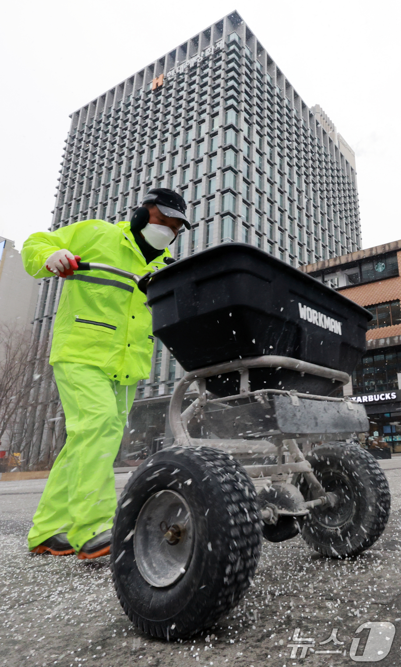 (서울=뉴스1) 이호윤 기자 = 눈이 내리는 12일 서울 광화문광장에서 작업자들이 염화칼슘을 뿌리고 있다. 2026.1.12/뉴스1