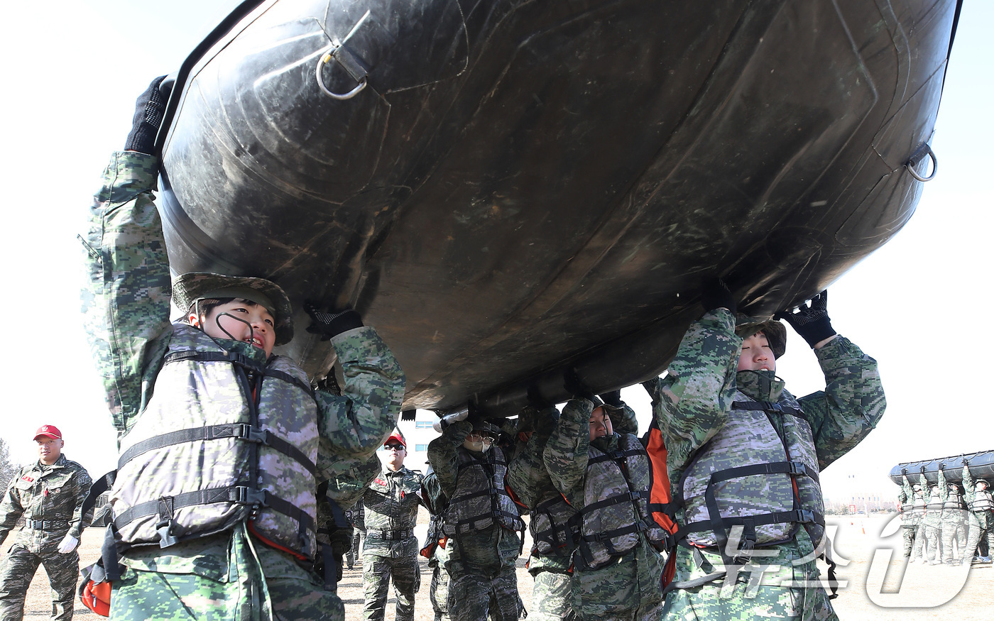 (포항=뉴스1) 공정식 기자 = 13일 경북 포항 해병대 1사단에서 열린 '2026년 겨울 해병대 캠프' 참가자들이 연병장에 IBS(소형고무보트) 도수운반 훈련을 하고 있다.12일 …