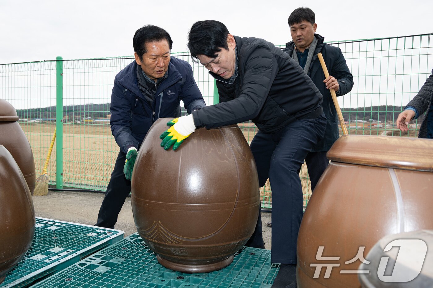 본문 이미지 - 정청래 더불어민주당 대표가 14일 충남 당진시 백석올미마을기업을 방문해 장독 옮기기 작업을 하고 있다. 오른쪽은 한민수 당대표 비서실장. 2026.1.14/뉴스1 ⓒ News1 유승관 기자