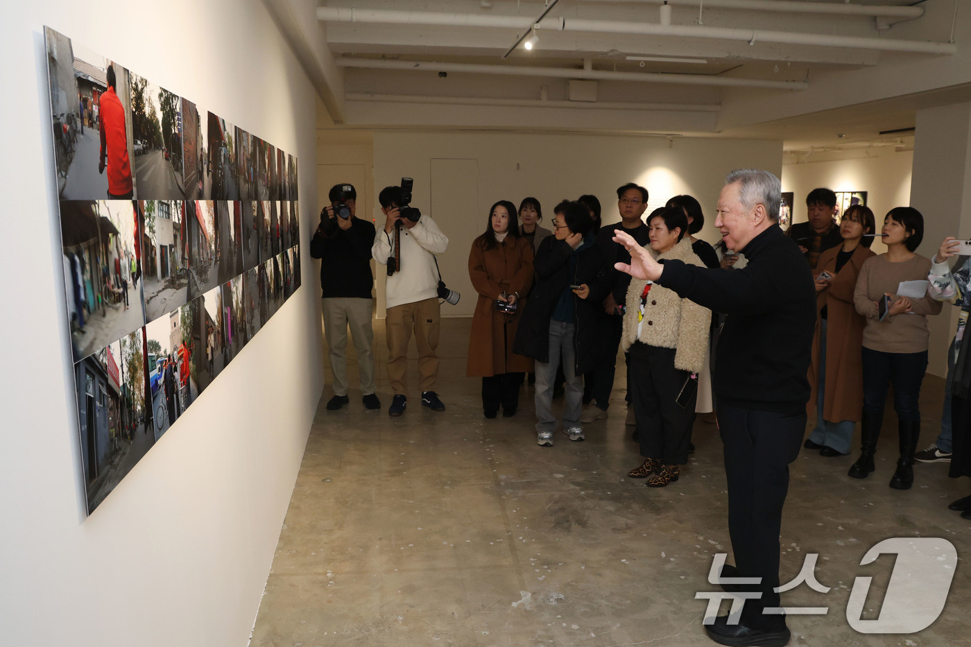 (서울=뉴스1) 이광호 기자 = 박용만 전 두산회장이 15일 오후 서울 중구 피크닉 전시관에서 열린 자신의 사진전 '휴먼 모먼트' 기자간담회에 앞서 참석자들에게 전시 작품에 대해 …