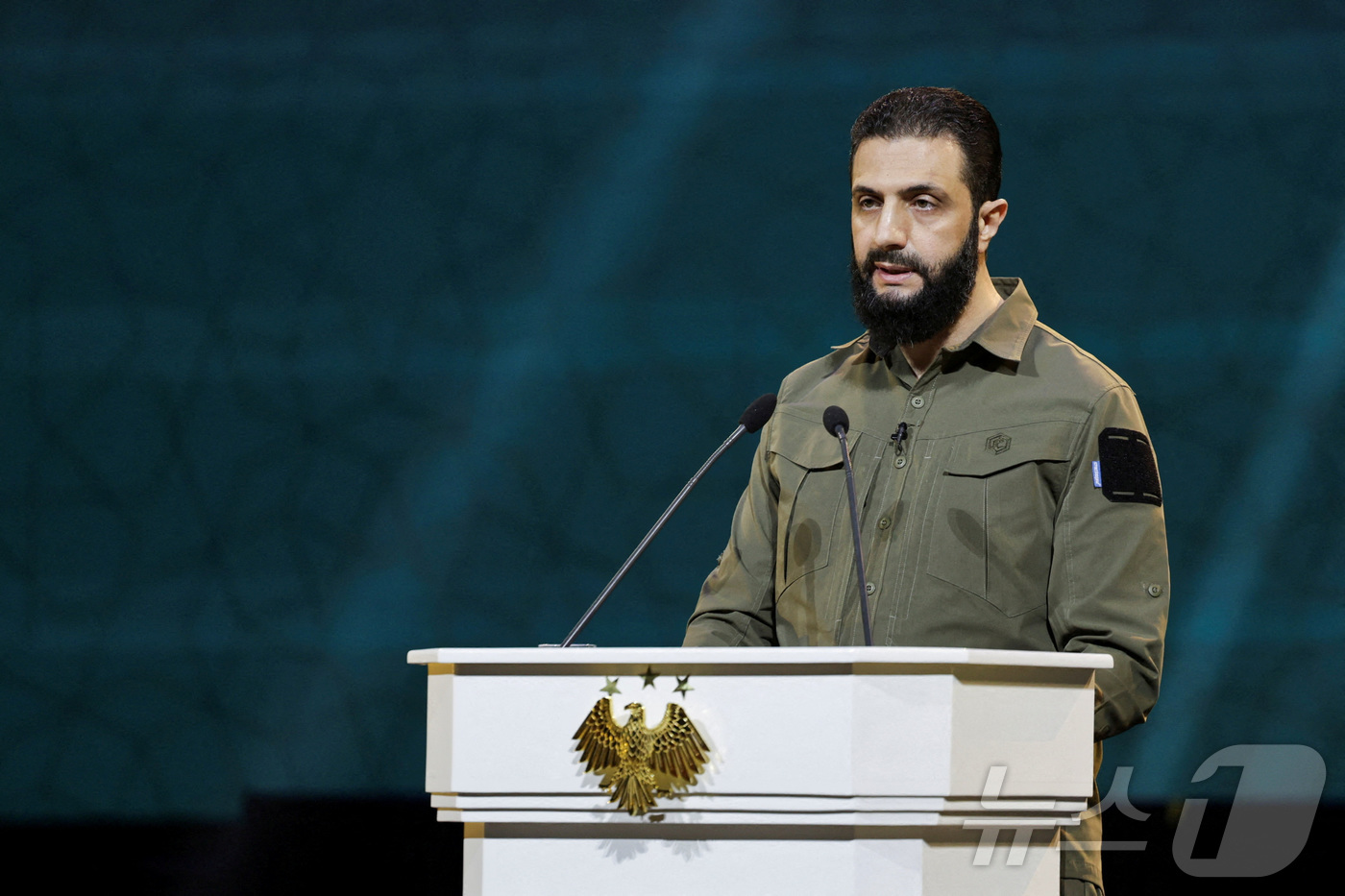 (다마스쿠스 로이터=뉴스1) 강민경 기자 = 아메드 알샤라 시리아 임시대통령이 지난해 12월 8일 다마스쿠스에서 바샤르 알 아사드 정권의 축출 1주년을 기념해 연설하고 있다. 20 …