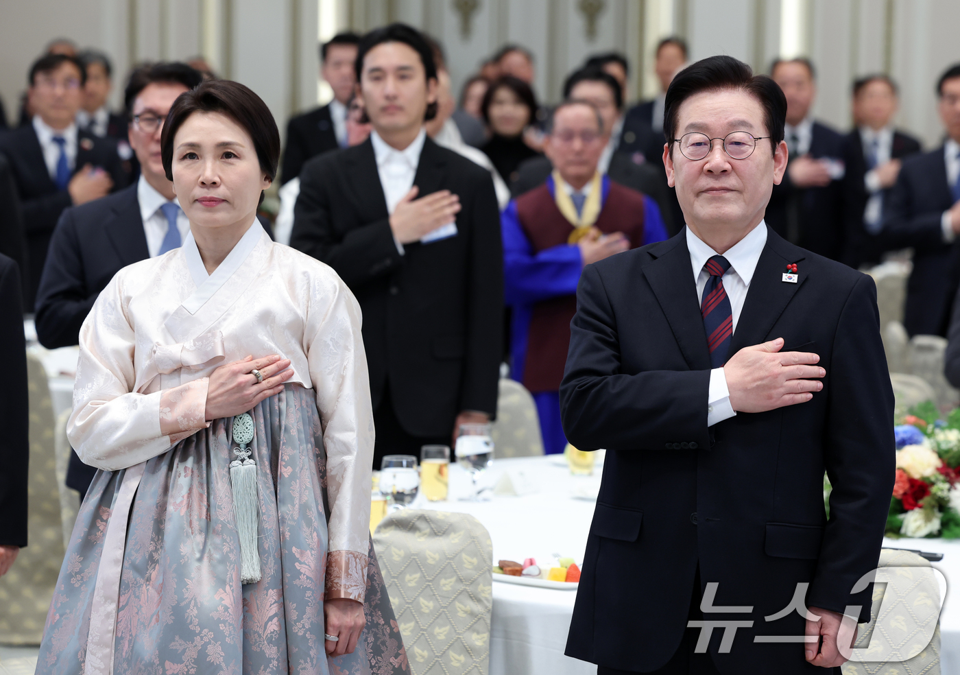 (서울=뉴스1) 이재명 기자 = 이재명 대통령과 김혜경 여사가 2일 청와대 영빈관에서 열린 2026년 신년 인사회에 참석해 국민의례를 하고 있다. 2026.1.2/뉴스1