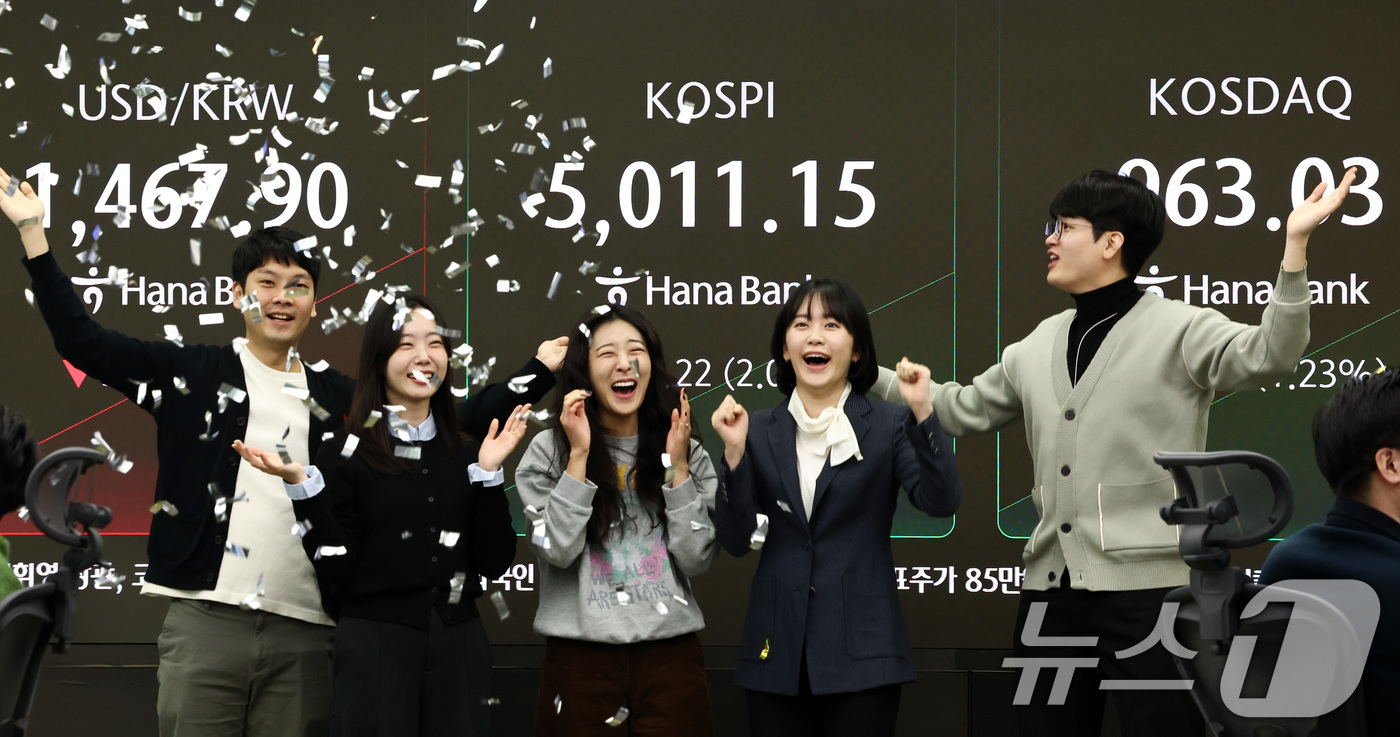 (서울=뉴스1) 최지환 기자 = 22일 오전 서울 중구 하나은행 본점 딜링룸 전광판에 코스피 지수가 장중 5000p를 넘자 직원들이 환호하고 있다. 2026.1.22/뉴스1